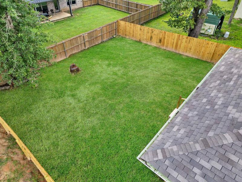 Fenced backyard with a patio area Fenced backyard with a patio area