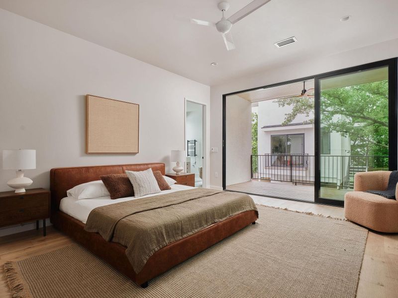 Spacious room featuring wood-finish flooring, a contemporary ceiling fan, and recessed lighting