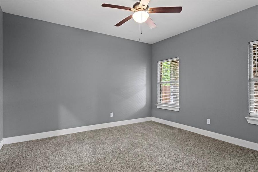 Unfurnished room featuring light carpet and ceiling fan Unfurnished room featuring light carpet and ceiling fan