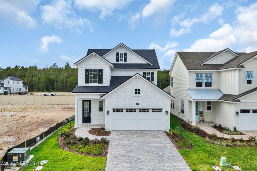 Front exterior of a new home in Seabrook Village at Seabrook, Ponte Vedra, FL, highlighting curb appeal (Image 22).