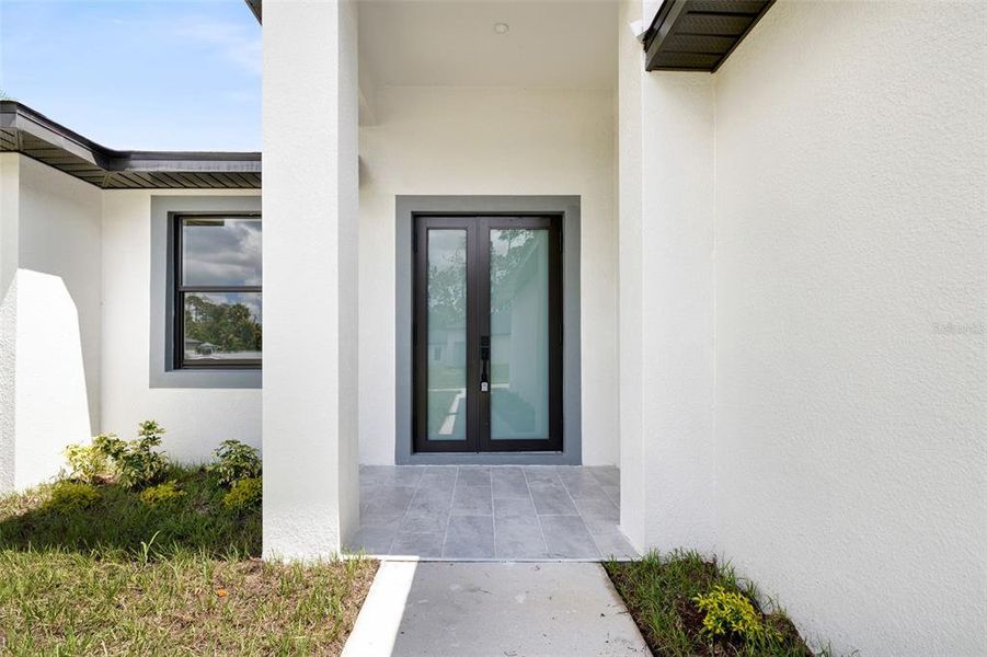 Front exterior of a new home in , Port Charlotte, FL, highlighting curb appeal (Image 1).