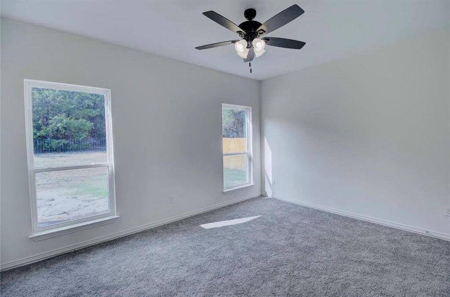 Unfurnished room featuring carpet floors and ceiling fan Unfurnished room featuring carpet floors and ceiling fan