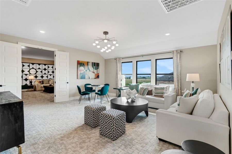 Carpeted living room featuring recessed lighting and lofted ceiling Carpeted living room featuring recessed lighting and lofted ceiling