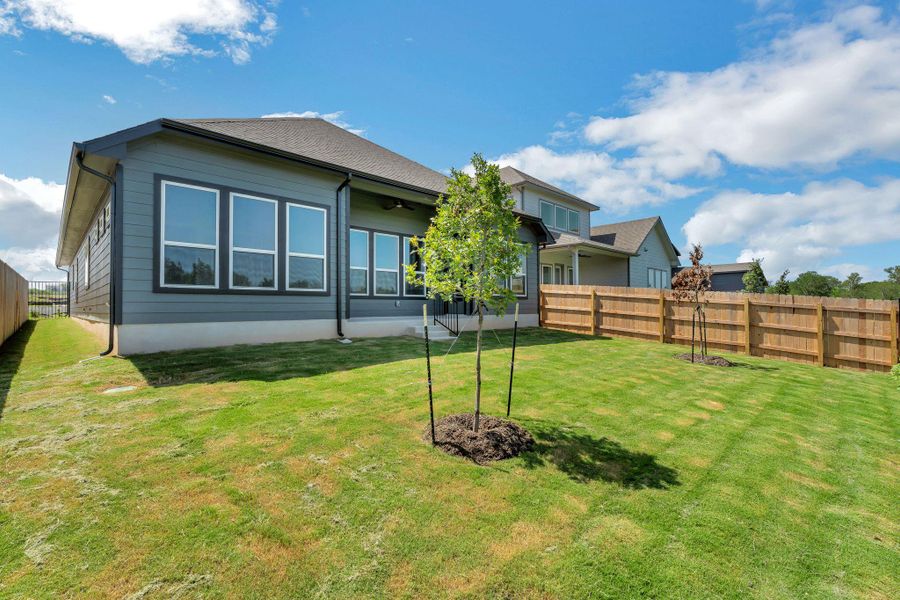 Back of house featuring a ceiling fan Back of house featuring a ceiling fan
