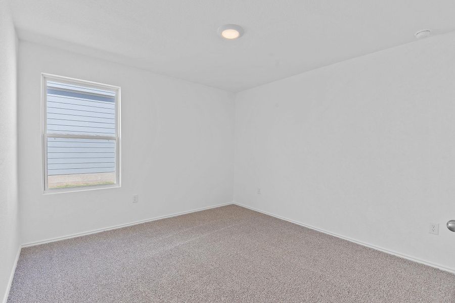 Empty room with carpet and baseboards