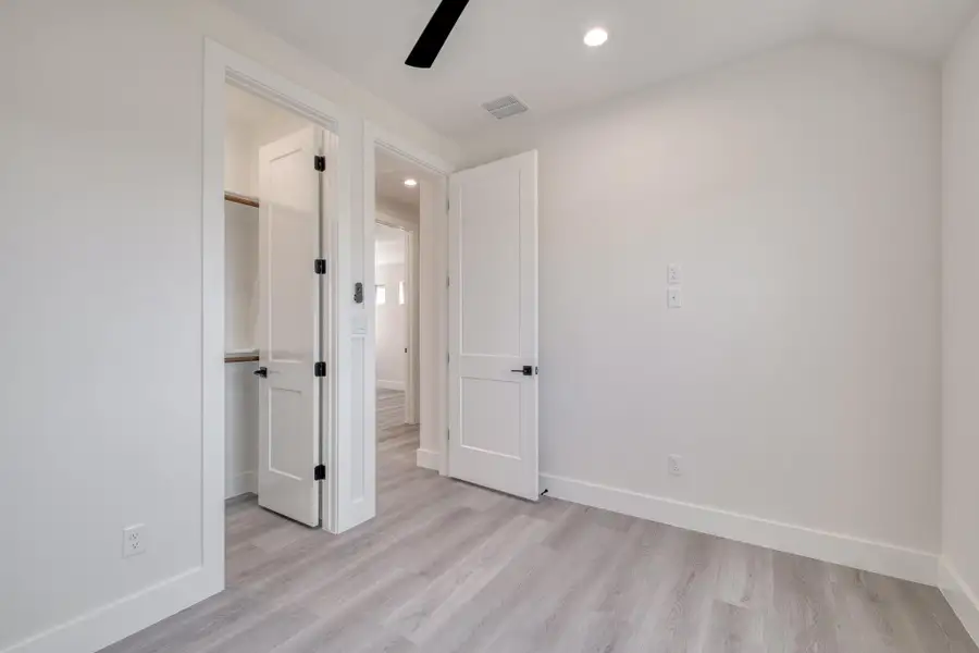 Spare room featuring visible vents, a ceiling fan, recessed lighting, light wood finished floors, and baseboards