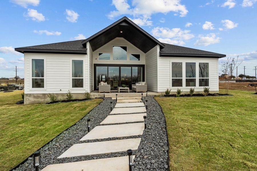 Front exterior of a new home in Lariat, Liberty Hill, TX, highlighting curb appeal (Image 26).