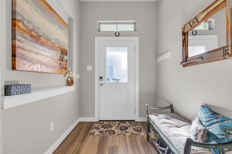 Foyer entrance with hardwood / wood-style floors