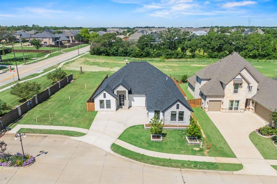 Modern single-story residence with a dark shingle roof and a light-colored brick and siding exterior Modern single-story residence with a dark shingle roof and a light-colored brick and siding exterior
