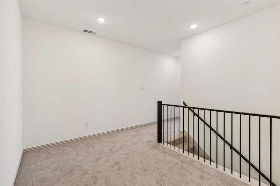 The loft at the top of the stairs provides ample space for a reading nook or pocket office.