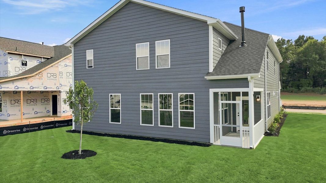 Refined rear exterior with a stylish screened-in porch for dining, relaxing, or entertaining in Anderson, SC
