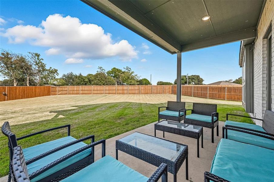 Fenced backyard with a patio and an outdoor hangout area