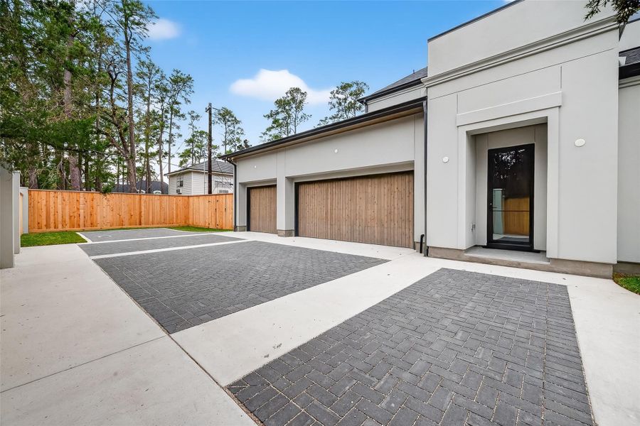 Pavers enhance the aesthetic and functional appeal of the driveway leading to the three-car garages. Pavers enhance the aesthetic and functional appeal of the driveway leading to the three-car garages.