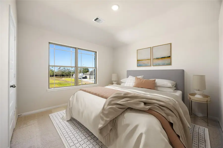 This secondary bedroom provides ample natural light and views of the outdoors. It also offers plush carpet flooring, neutral color wall, recessed lighting, and ample closet space. *Virtually Staged This secondary bedroom provides ample natural light and views of the outdoors. It also offers plush carpet flooring, neutral color wall, recessed lighting, and ample closet space. *Virtually Staged