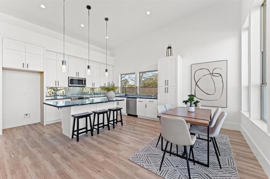 A spacious open floor plan seamlessly connects the living, dining, and kitchen areas, ideal for modern living and entertaining.