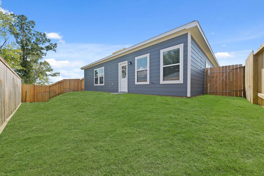 A house with a fence around it. A house with a fence around it.