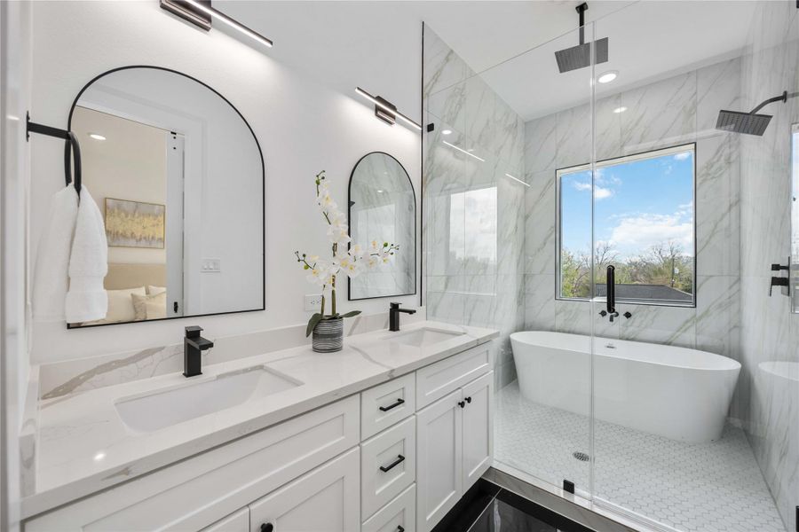This spa-inspired primary bathroom features a stunning double-vanity with quartz countertops, sleek matte-black fixtures, and elegant arched mirrors, complemented by a frameless glass shower with floor-to-ceiling marble-style tile and a freestanding soaking tub positioned beneath a large picture window for a serene, resort-like atmosphere.
