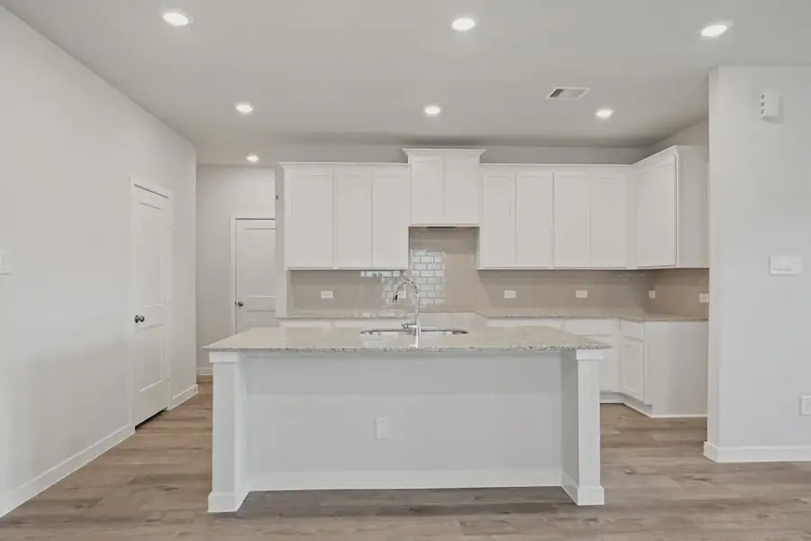 A kitchen with white cabinets. A kitchen with white cabinets.