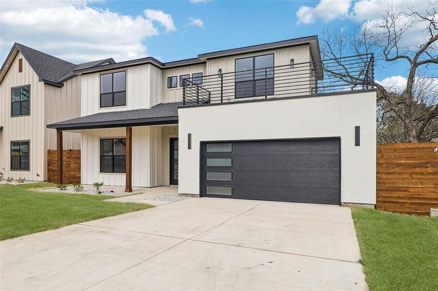 View of front of property featuring driveway, board and batten siding, a porch, roof with shingles, and a garage