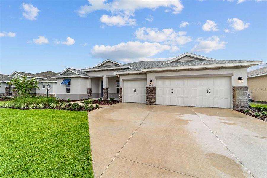 Front exterior of a new home in On Top of the World Communities, Ocala, FL, highlighting curb appeal (Image 19). Front exterior of a new home in On Top of the World Communities, Ocala, FL, highlighting curb appeal (Image 19).