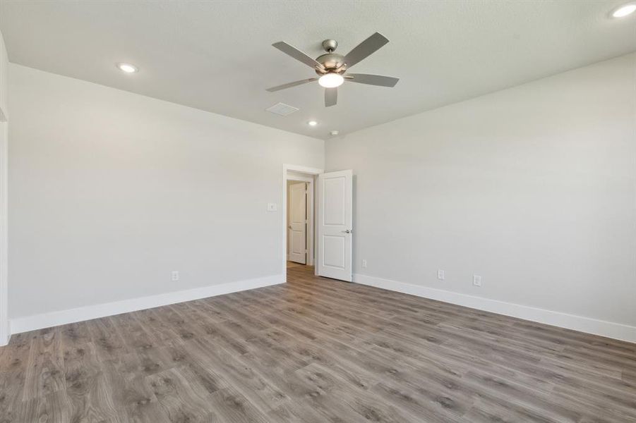 Spare room with light hardwood / wood-style flooring and ceiling fan