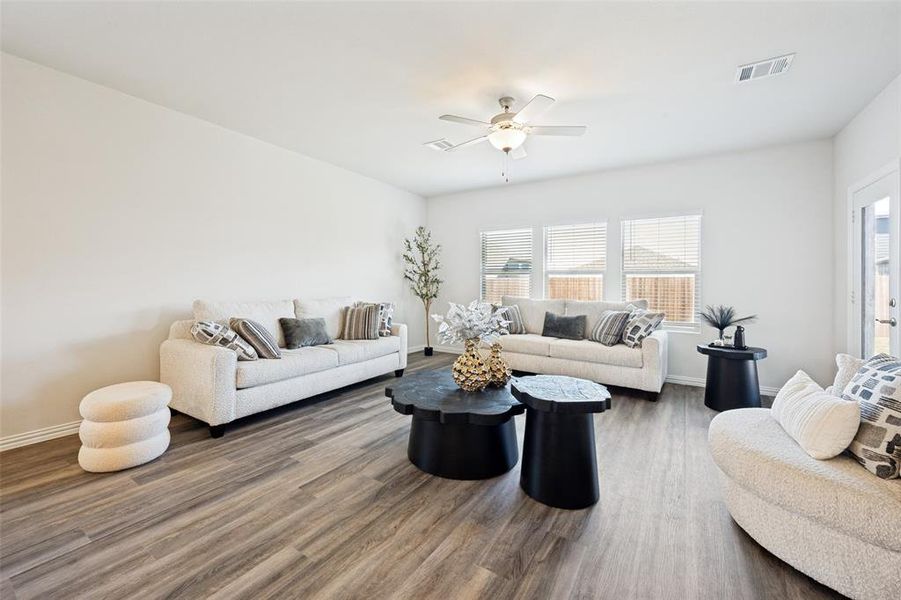 Spacious interior with neutral white walls and wood-finish flooring Spacious interior with neutral white walls and wood-finish flooring