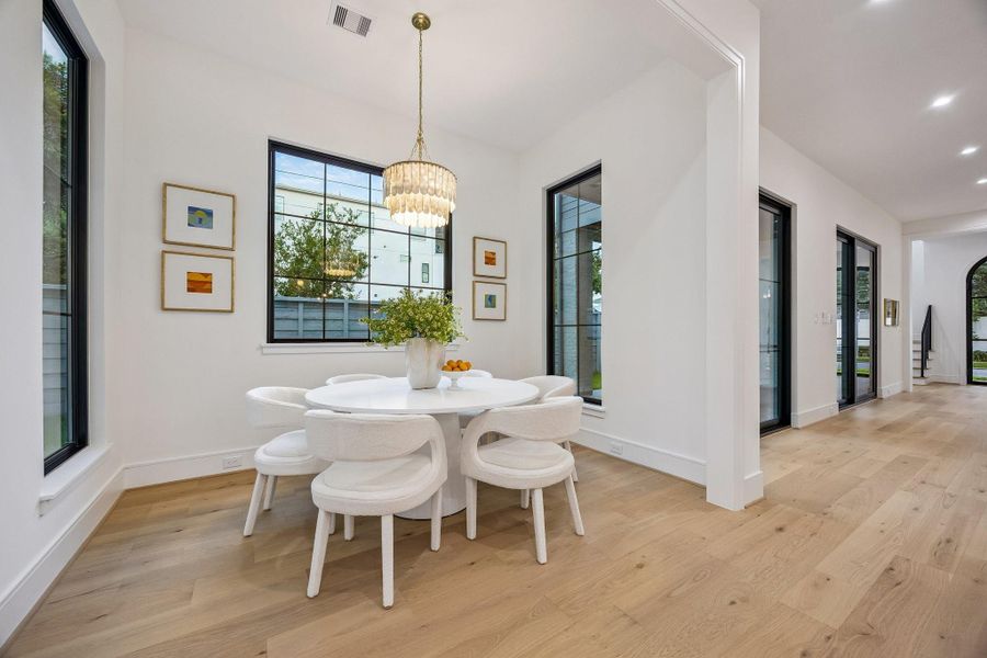 Spacious Breakfast Room with a Modern 5 Light, Two-Tiered Faceted Shell Chandelier.