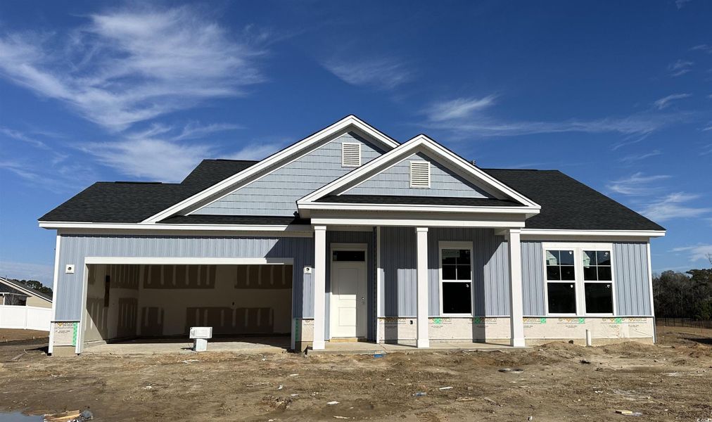 View of front of home featuring roof with shingles, a porch, a garage, and board and batten siding