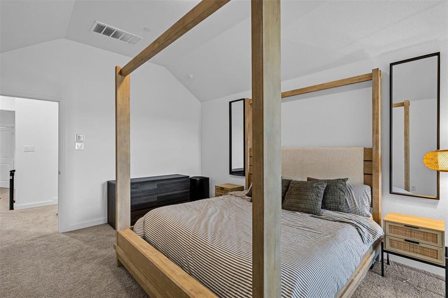 Bedroom featuring light colored carpet and baseboards