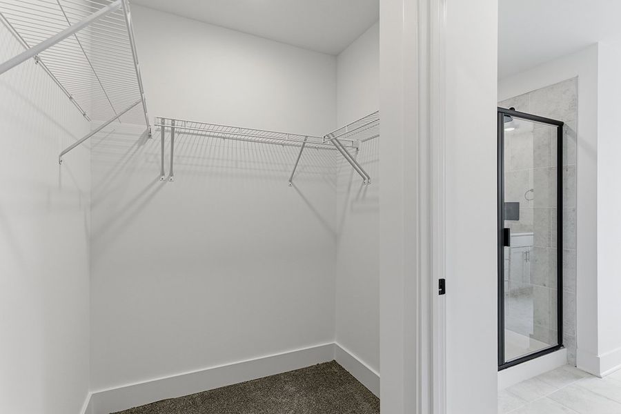 A white staircase with a glass door.