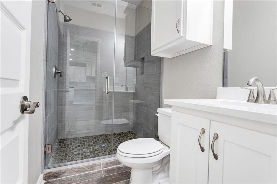 Full bathroom with vanity and a shower stall