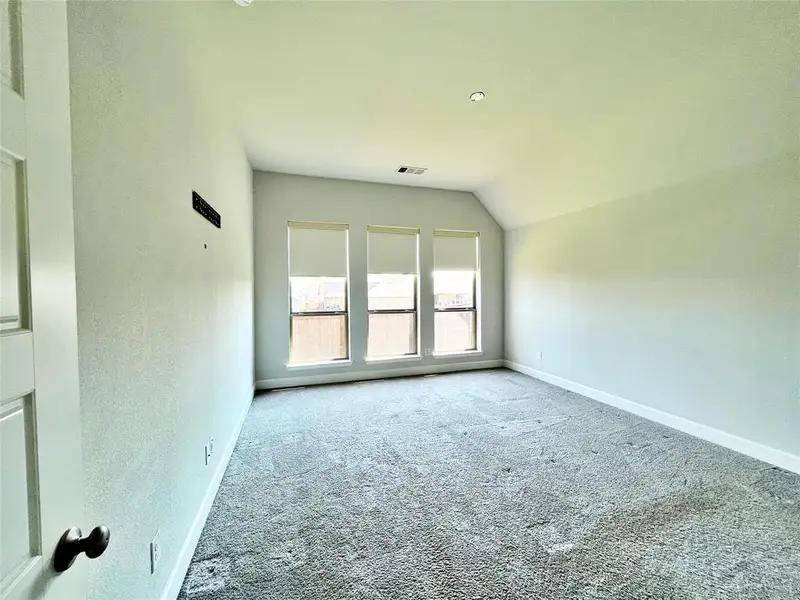 Carpeted empty room featuring baseboards Carpeted empty room featuring baseboards