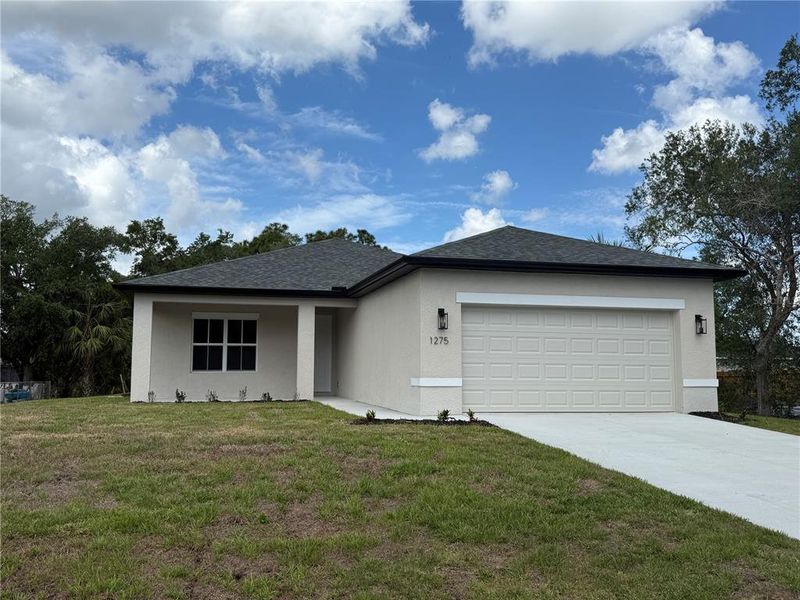 Front exterior of a new home in , Port Charlotte, FL, highlighting curb appeal (Image 15).