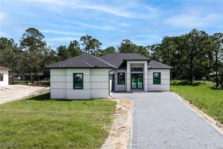 Front exterior of a new home in , Lehigh Acres, FL, highlighting curb appeal (Image 19).