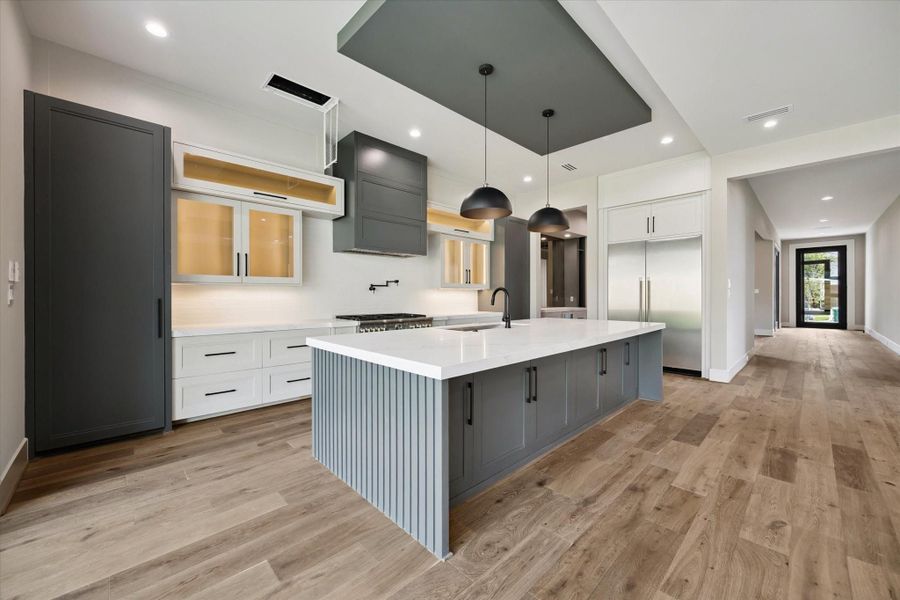 Lighted cabinets, under-cabinet lighting, and thoughtful design details highlight the craftsmanship while ensuring every corner of the kitchen is both beautiful and practical.