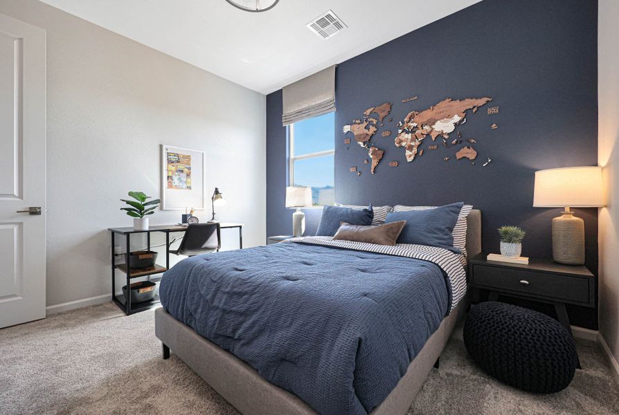 A bedroom with a bed and a desk.