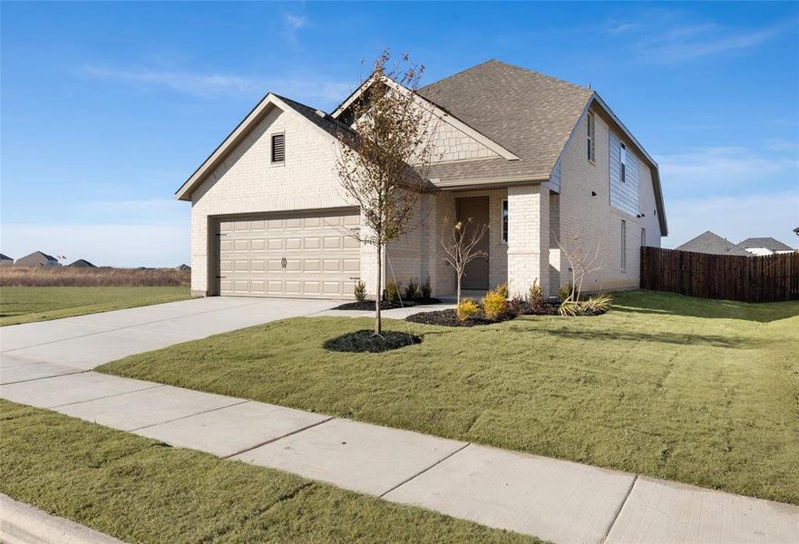 Front exterior of a new home in Elevon, Lavon, TX, highlighting curb appeal (Image 2). Front exterior of a new home in Elevon, Lavon, TX, highlighting curb appeal (Image 2).