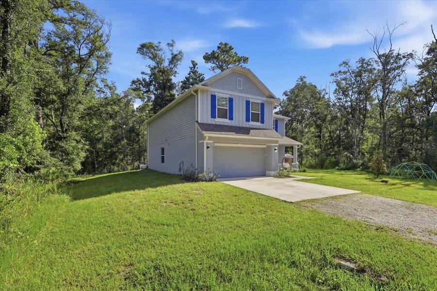 Front exterior of a new home in Flagler Estates, Hastings, FL, highlighting curb appeal (Image 29).