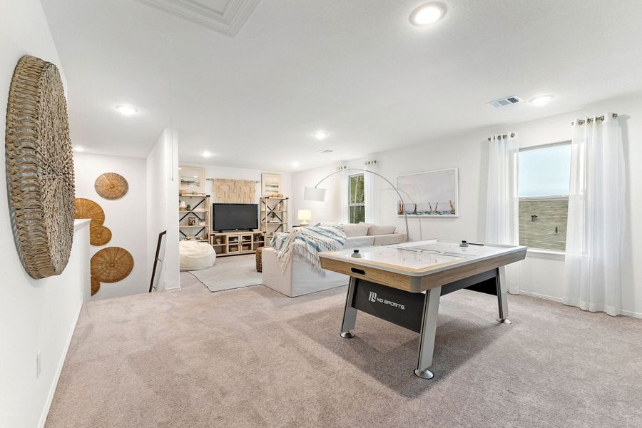 A room with a bed and a desk.