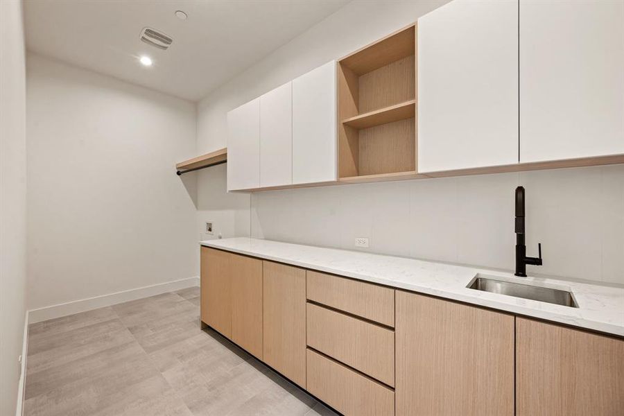 Mudroom/utility space with clean modern cabinetry and ample storage. Mudroom/utility space with clean modern cabinetry and ample storage.