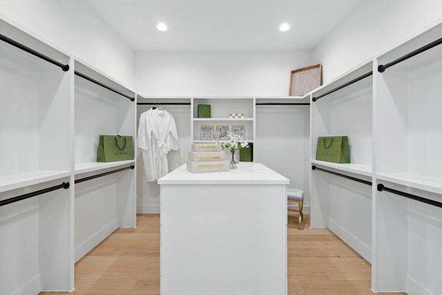 Walk in closet with light wood finished floors Walk in closet with light wood finished floors