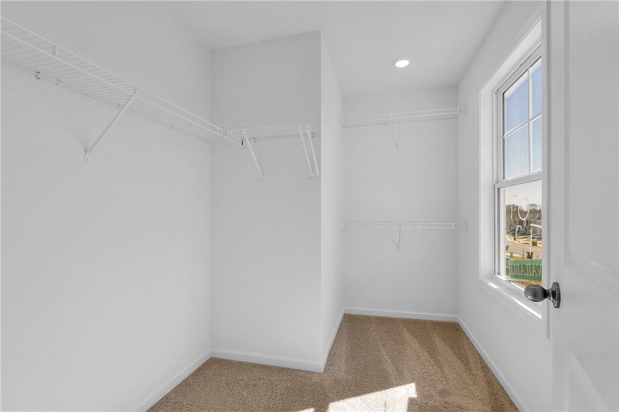 This spacious walk-in closet offers ample storage