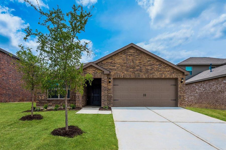 View of front of home featuring a garage and a front yard