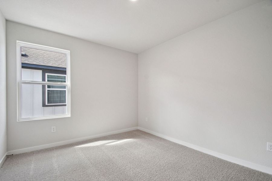 A room with a window and a carpet.