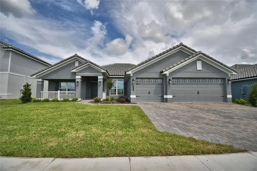 Front exterior of a new home in , Auburndale, FL, highlighting curb appeal (Image 1). Front exterior of a new home in , Auburndale, FL, highlighting curb appeal (Image 1).