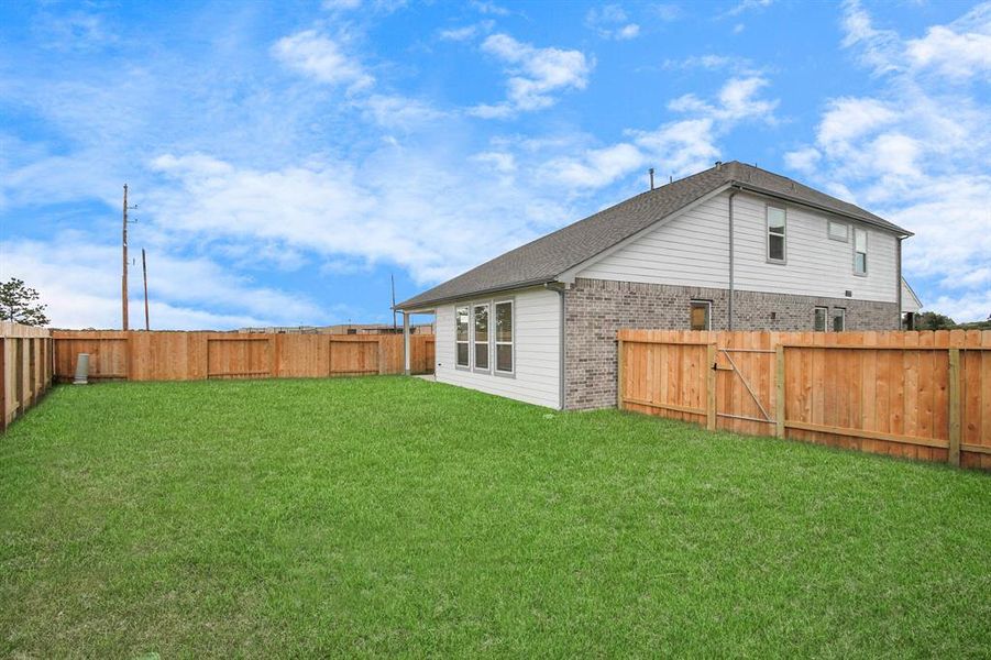 Step into a world of outdoor possibilities with this remarkable backyard and its charming covered patio. From playtime for the kids to relaxation for the adults, this space offers the best of both worlds.