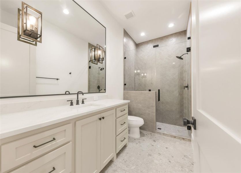 Bathroom with vanity, a shower stall, and recessed lighting