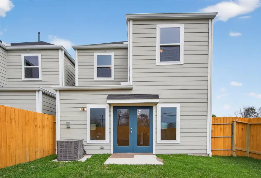 Private backyard retreat featuring a fully fenced yard, lush green space, and elegant double doors that seamlessly connect indoor and outdoor living. Private backyard retreat featuring a fully fenced yard, lush green space, and elegant double doors that seamlessly connect indoor and outdoor living.