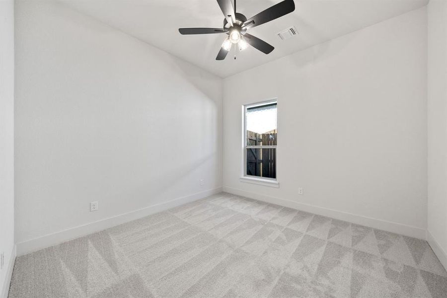 Unfurnished room with light carpet and a ceiling fan