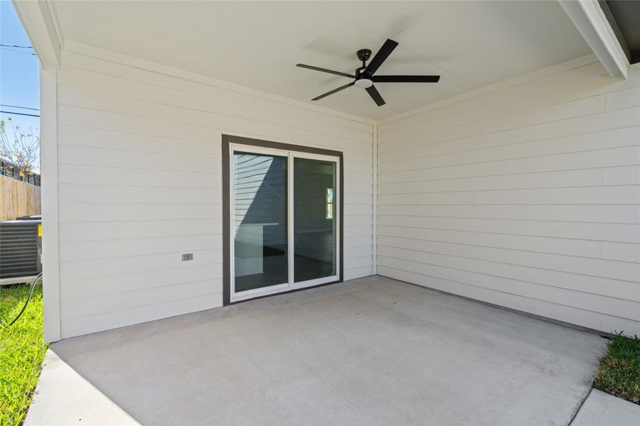 Covered back patio with ceiling fan keeping you cool